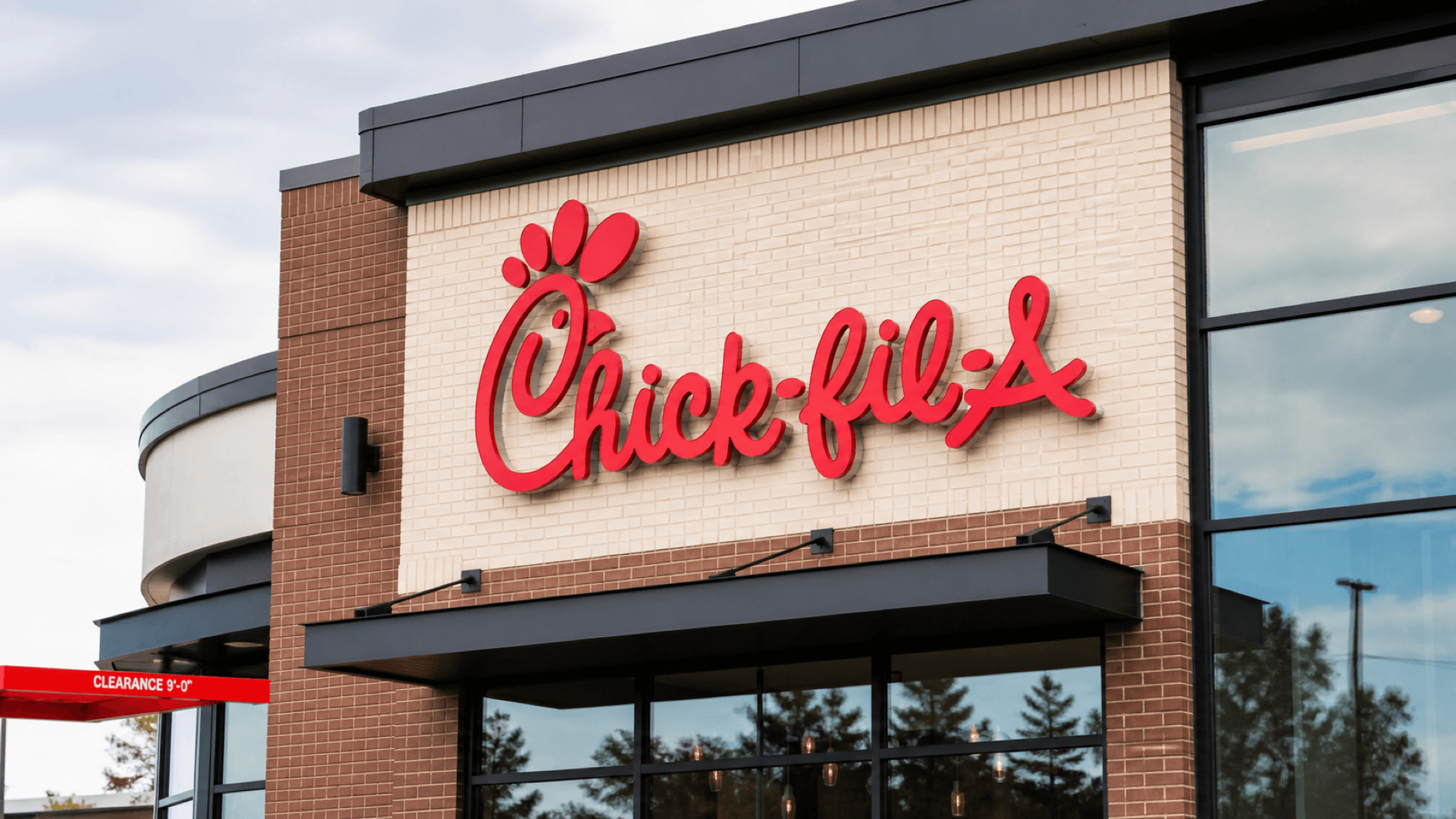 A close-up of the Chick-fil-A sign outside a modern restaurant storefront